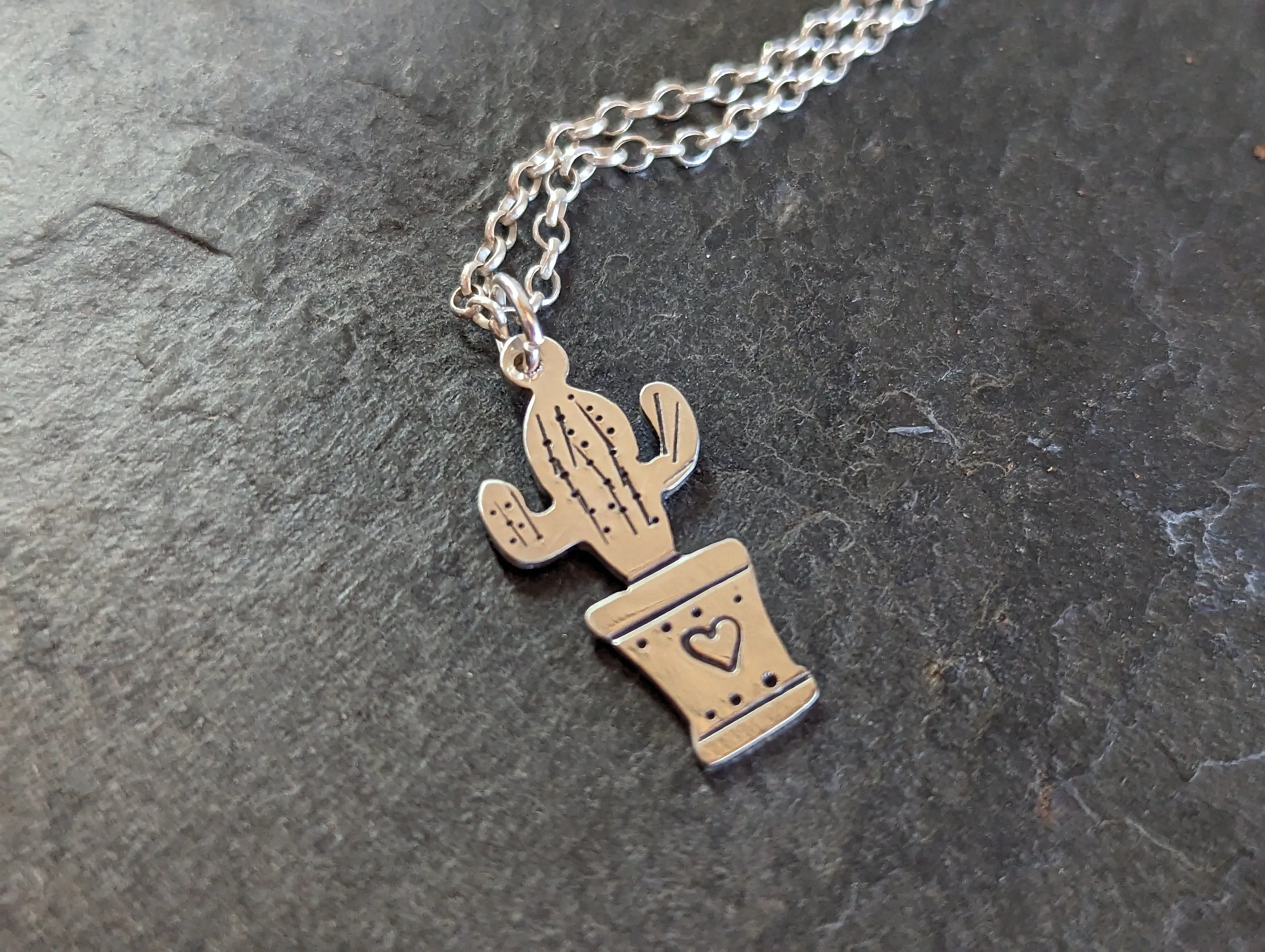 Silver cactus charm and small inspirational drawing