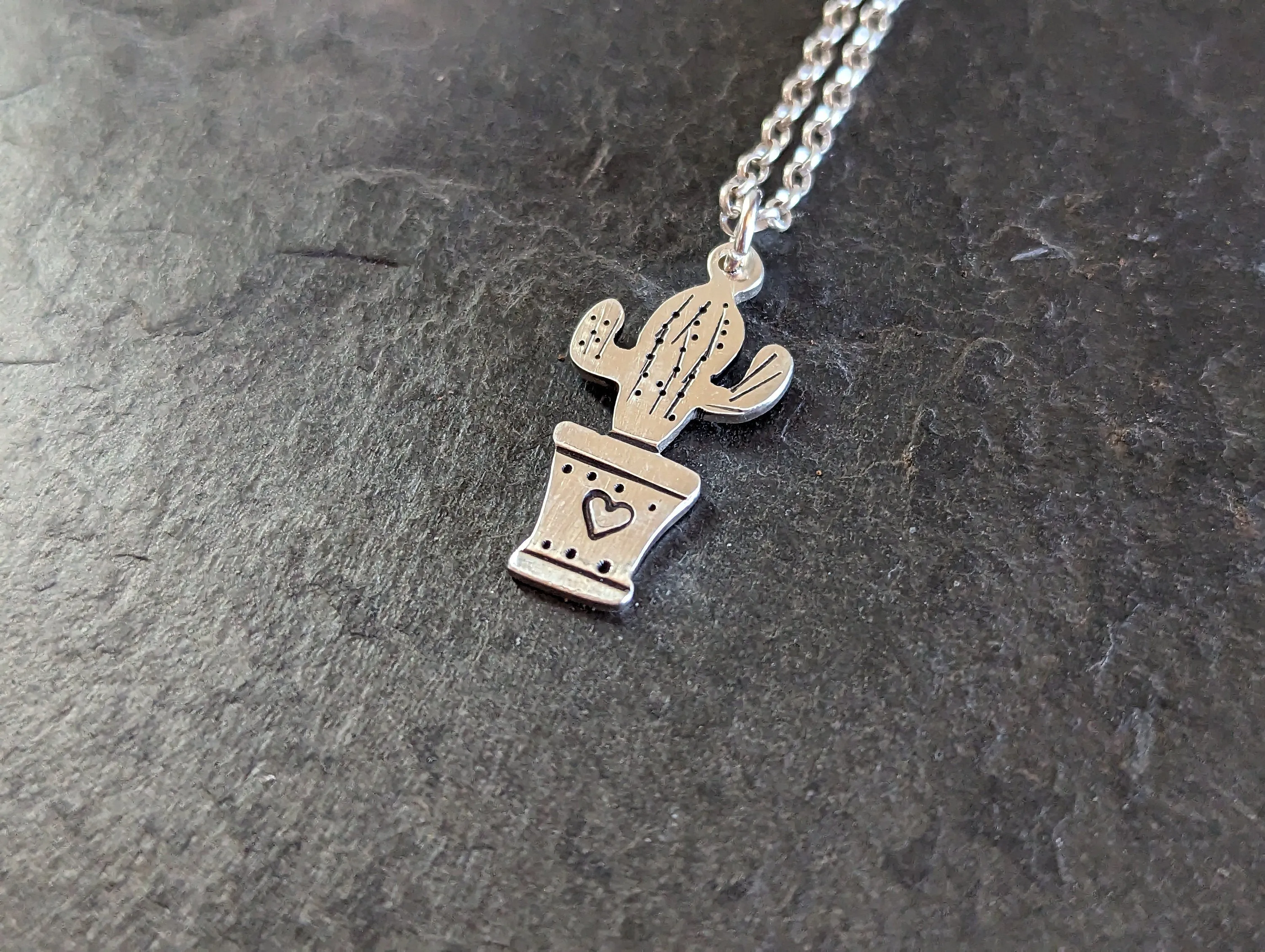 Silver cactus charm and small inspirational drawing