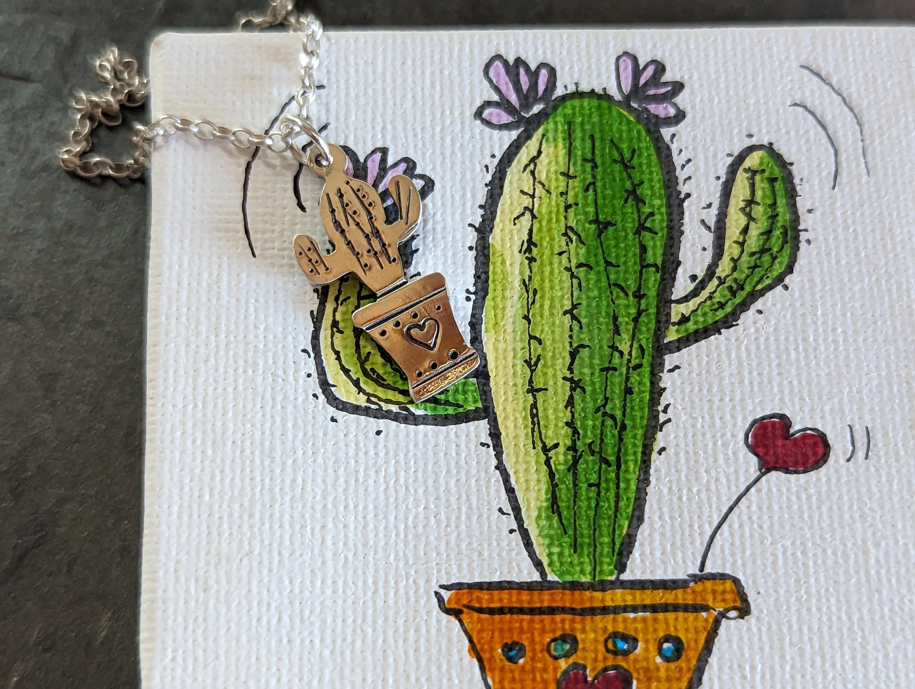 Silver cactus charm and small inspirational drawing